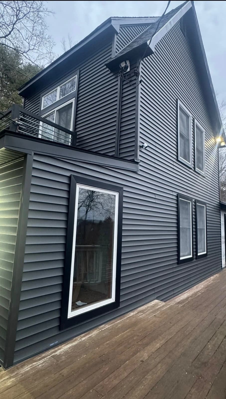 Luxury modern home exterior with architectural siding and integrated lighting